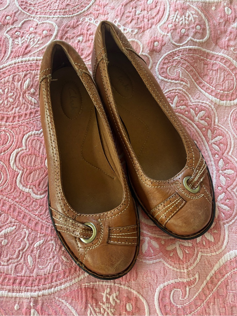 Clark’s brown leather flats with buckle detail